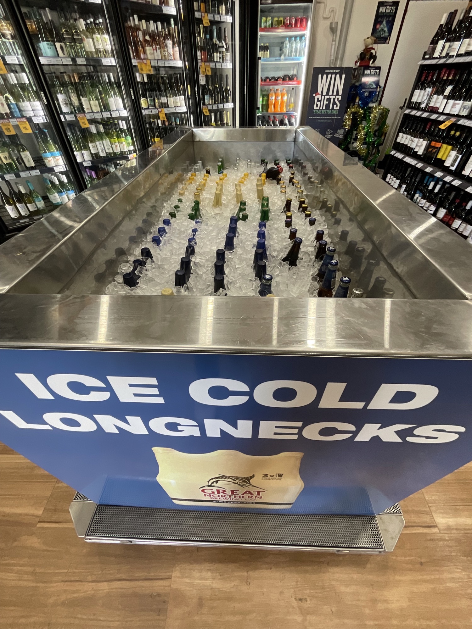 Ice-filled longneck display tub in a bottle shop